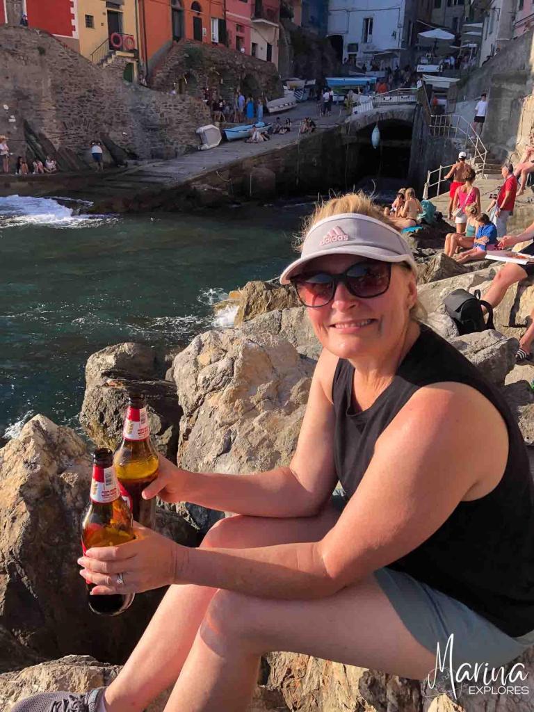 Riomaggiore harbor, Marina holding beer, Cinque Terre, Italy