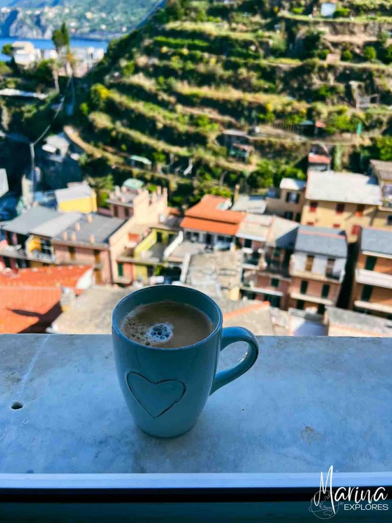 Coffee cup with terraces on hills, Manarola, Cinque Terre, Italy