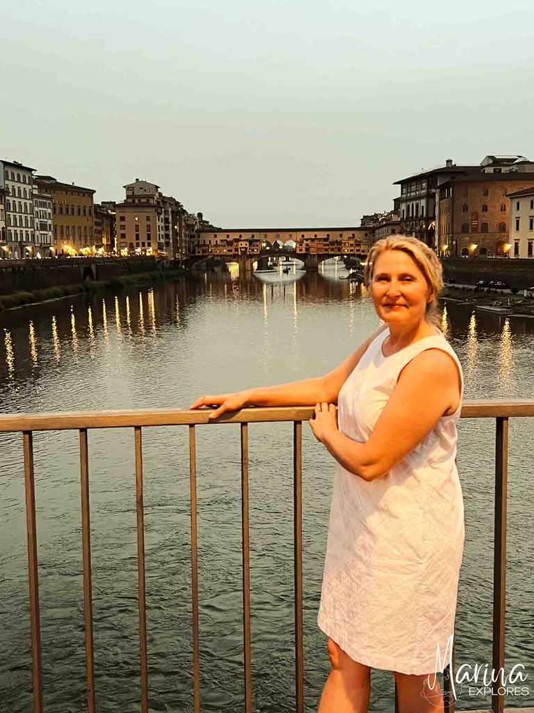Marina overlooking Ponte Vecchio at night, white dress, Florence, Italy
