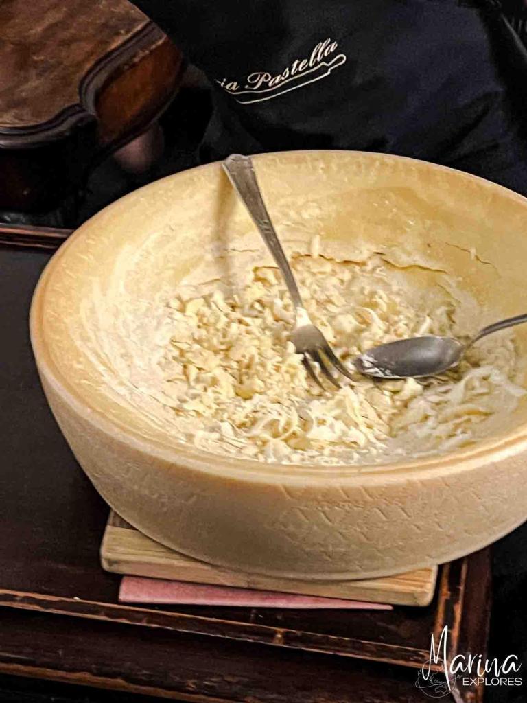 Close up view of pasta made in cheese wheel with grated truffle in Florence, Italy