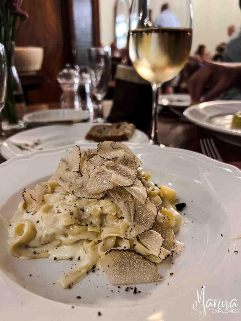 Plate of pasta made in cheese wheel with grated truffle in Florence, Italy