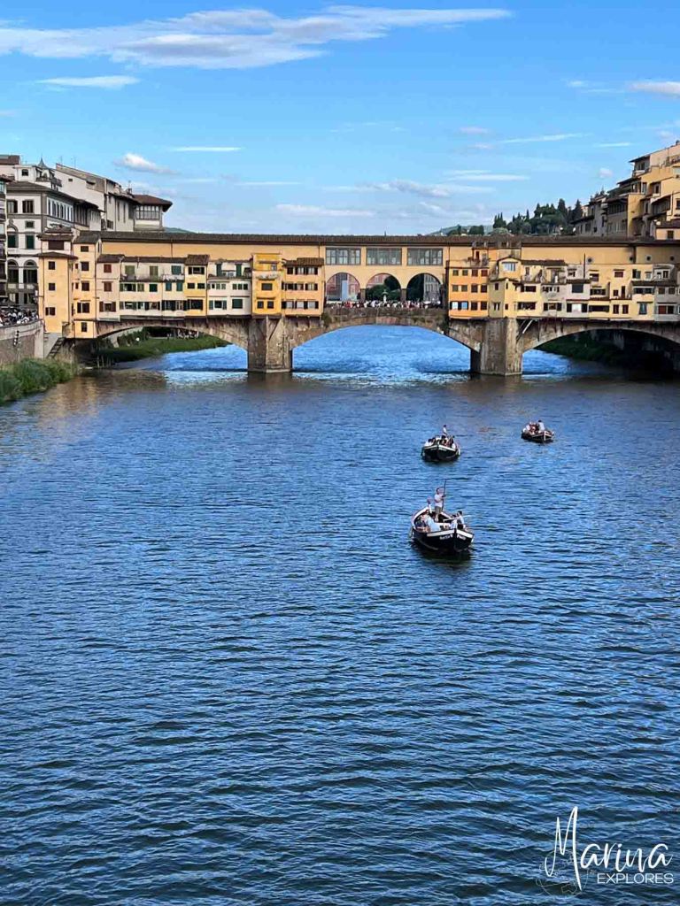Boats on Arno River near Ponte Vecchio Florence, Italy
