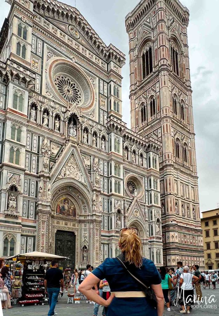 Marina looking up at exterior of cathedral in Florence, Italy