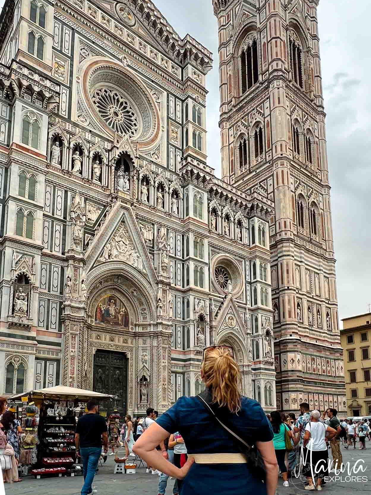 Marina looking up at exterior of cathedral in Florence, Italy