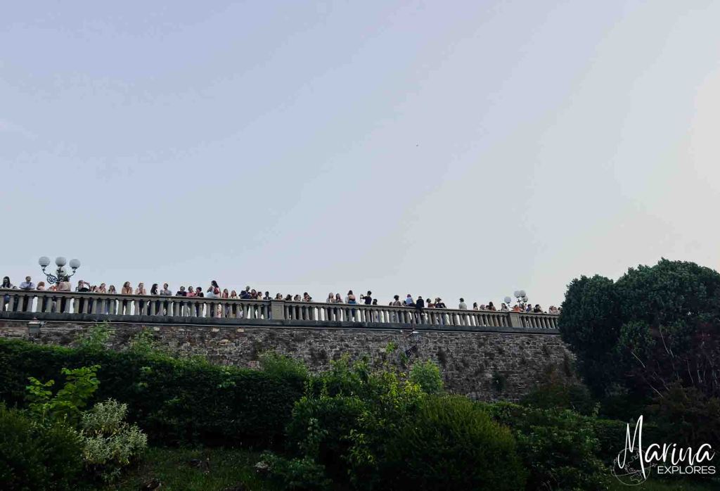 View of crowds at railing at Piazzale Michelangelo in Florence, Italy