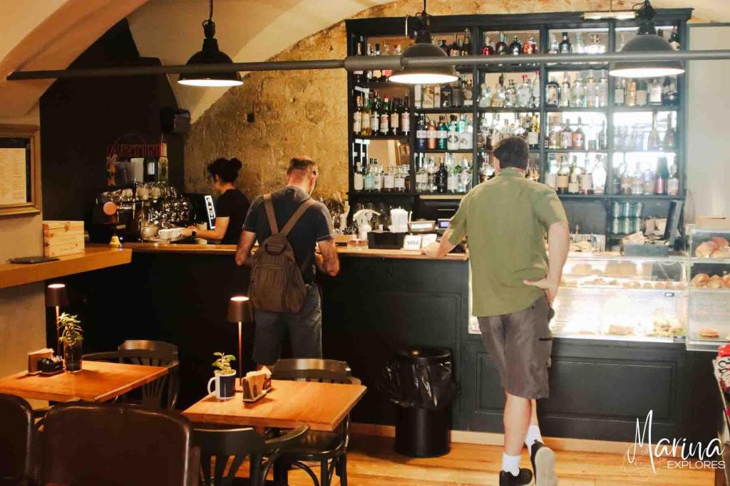 Ordering coffee at a counter in a cafe in Siena near Florence, Italy