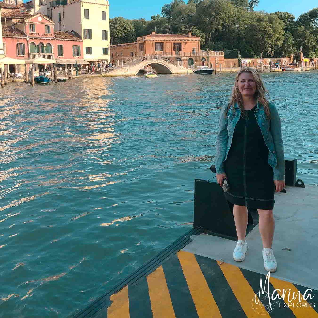 Marina standing on vaporetto dock outside train station Venice, Italy