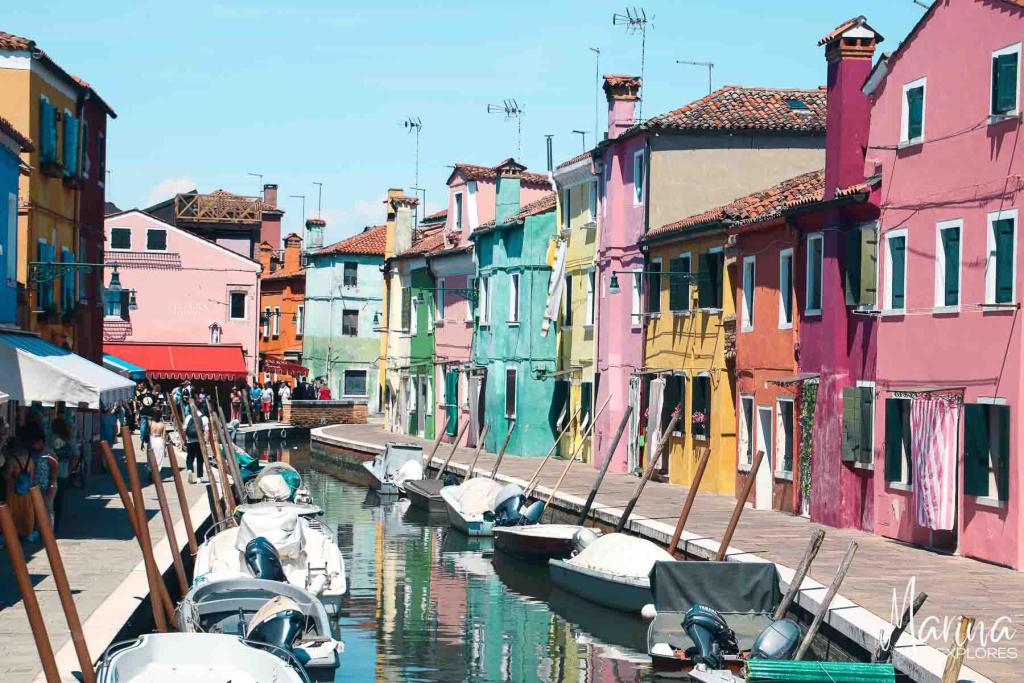 Colorful houses along small canal on Burano Island Venice, Italy