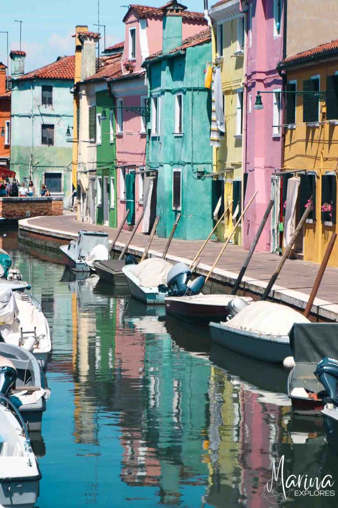Colorful houses along small canal on Burano Island Venice, Italy
