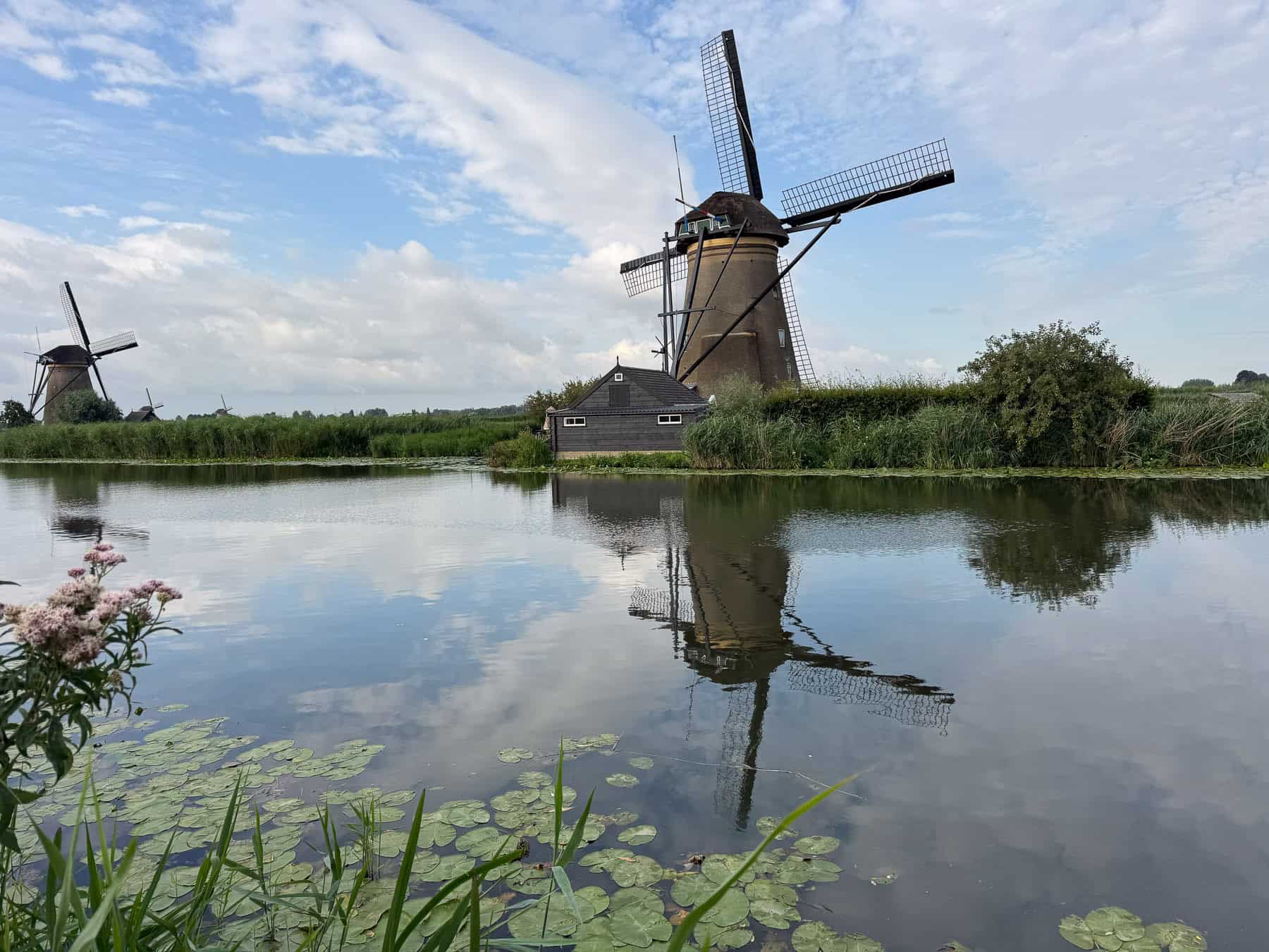 windmill reflecting on canal