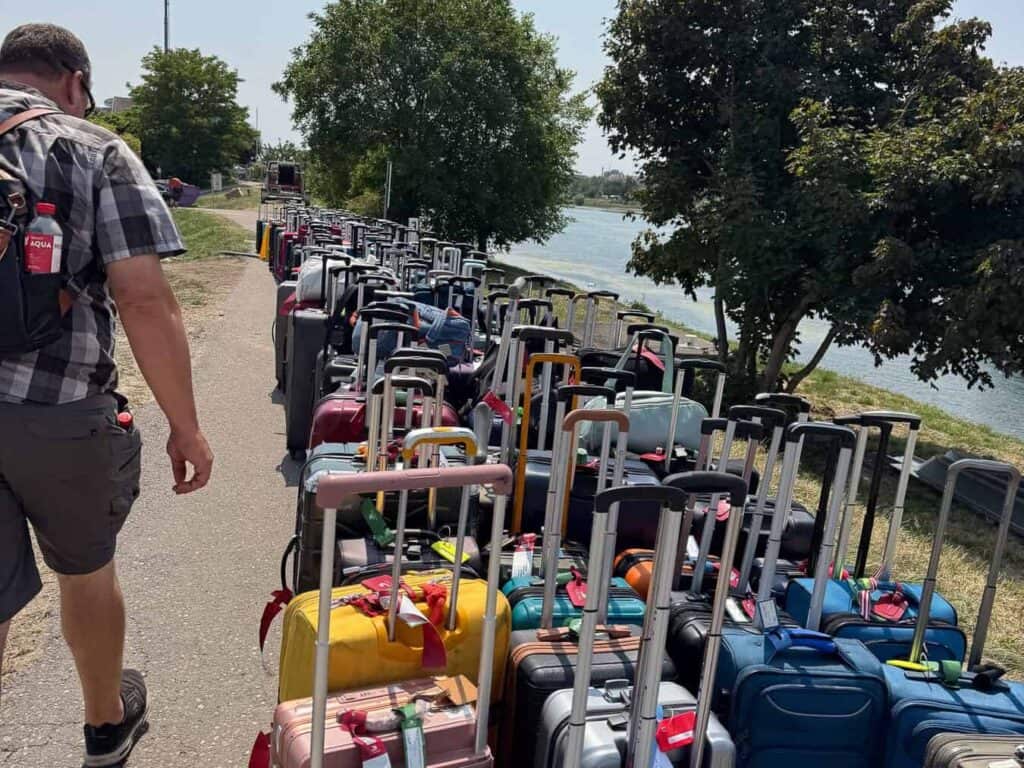 Viking ship swap luggage lined up to be moved by staff to ship
